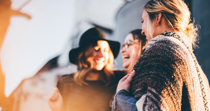 Three women talking and laughing