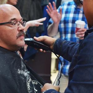 Man having moustache shaved off