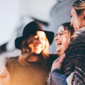 Three women talking and laughing