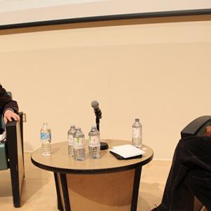 Comedian Rick Green and Dr. Ahmed sitting in armchairs and talking