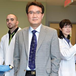 three scientists standing and looking forward