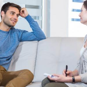 man and woman sitting on a couch and talking