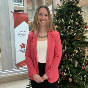 Jillian Crabbe standing in front of Christmas tree