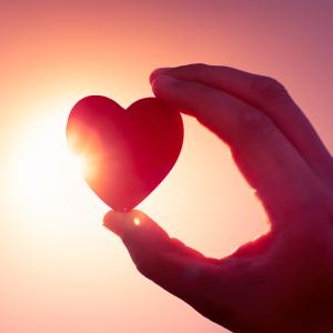 Hand holding a symbolic heart