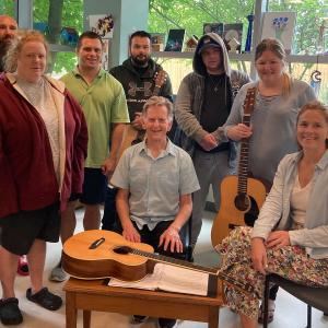 Ottawa musician Michael Fahey (centre) and recreation therapist Ashleigh McGuinty (seated at right) with some members of The Royal’s guitar group.