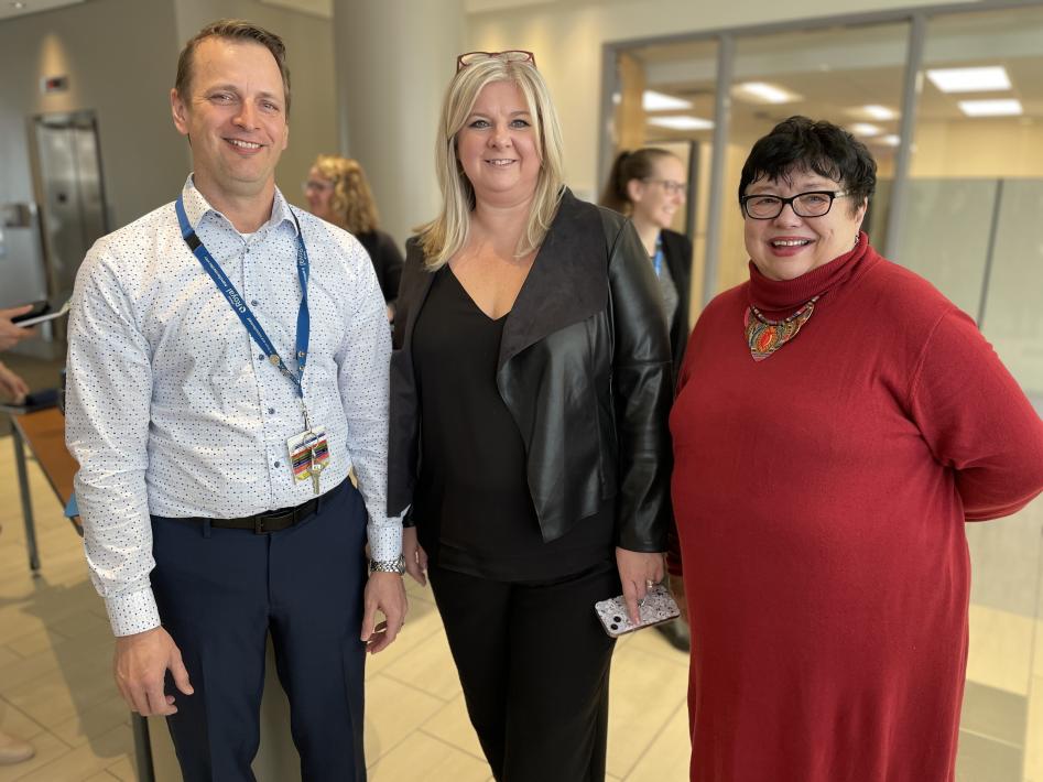 Three individuals networking during Research Week 2024